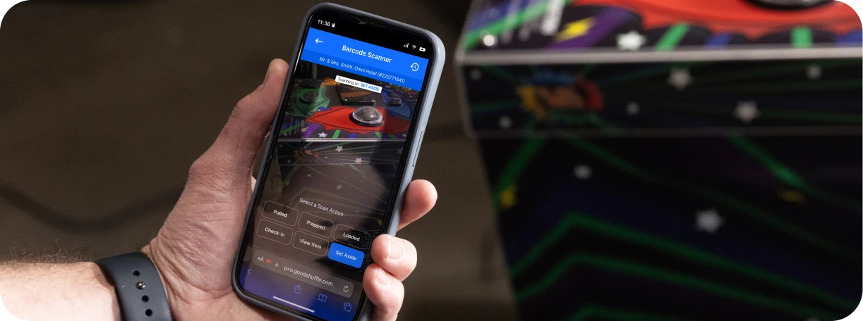 Event professional using Goodshuffle Pro's mobile Barcoding feature on smartphone to scan rental inventory.