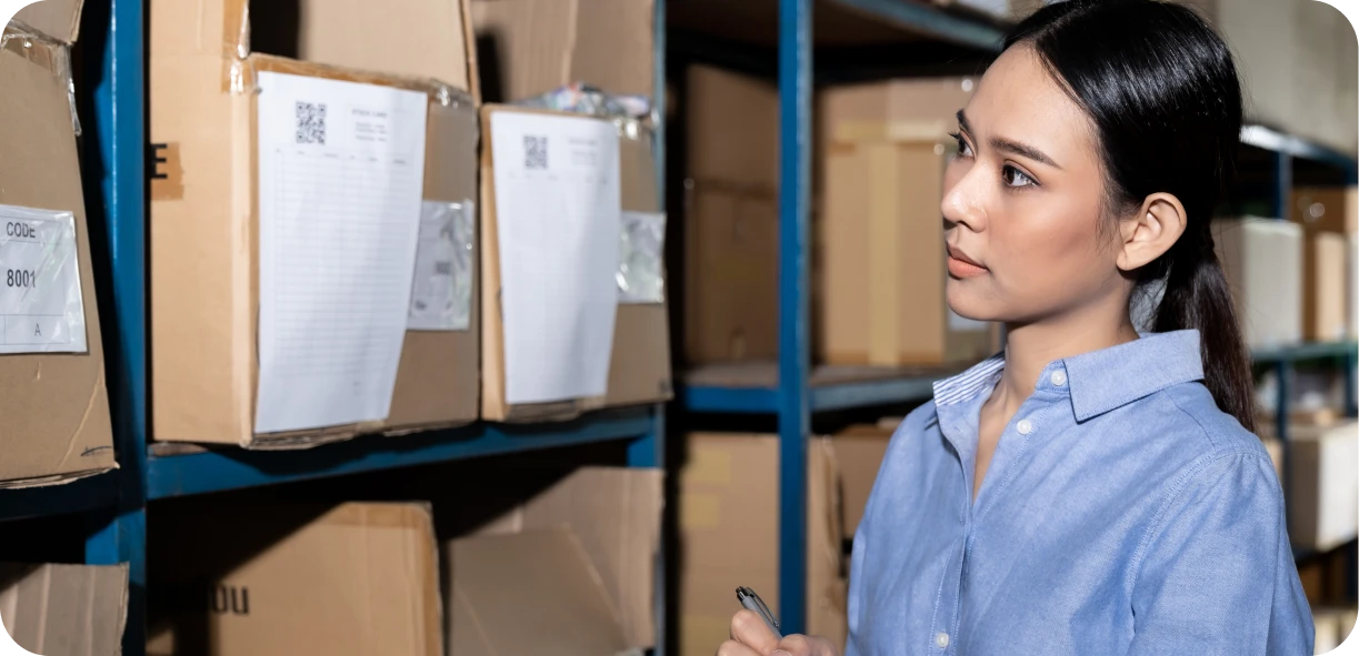 Event rental staff member cataloging inventory and checking origin countries on product labels