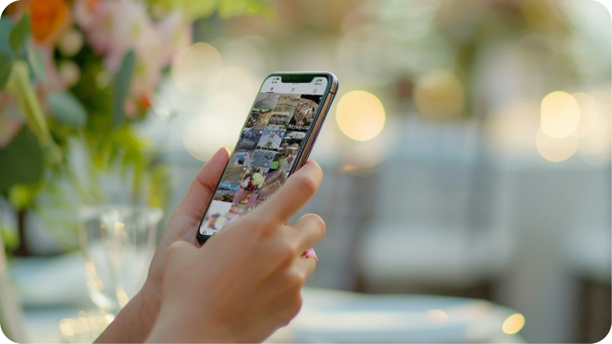 Event professional using Instagram on phone with event setup in background 